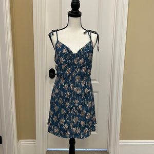 Sun dress, blue with floral print.